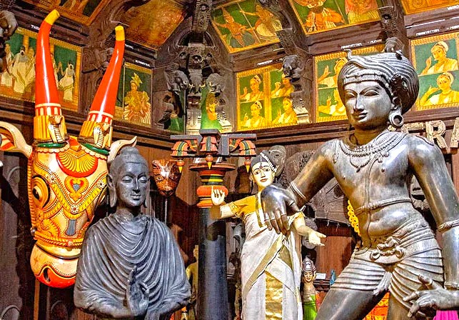 Intricately adorned interior of Mysore Folk Lore Museum in Karnataka, India showcases traditional sculptures, ritual masks, murals, cultural artifacts and mythological figures celebrating regional heritage.