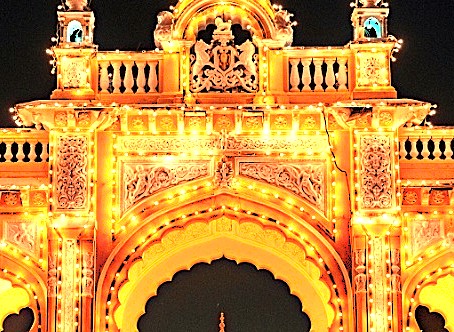 The illuminated Mysore Palace arch in Mysore, Karnataka, India, a key attraction near Mysore Palace for tourists visiting Bangalore and the Tipu Sultan Palace ('Tiger of Mysore').