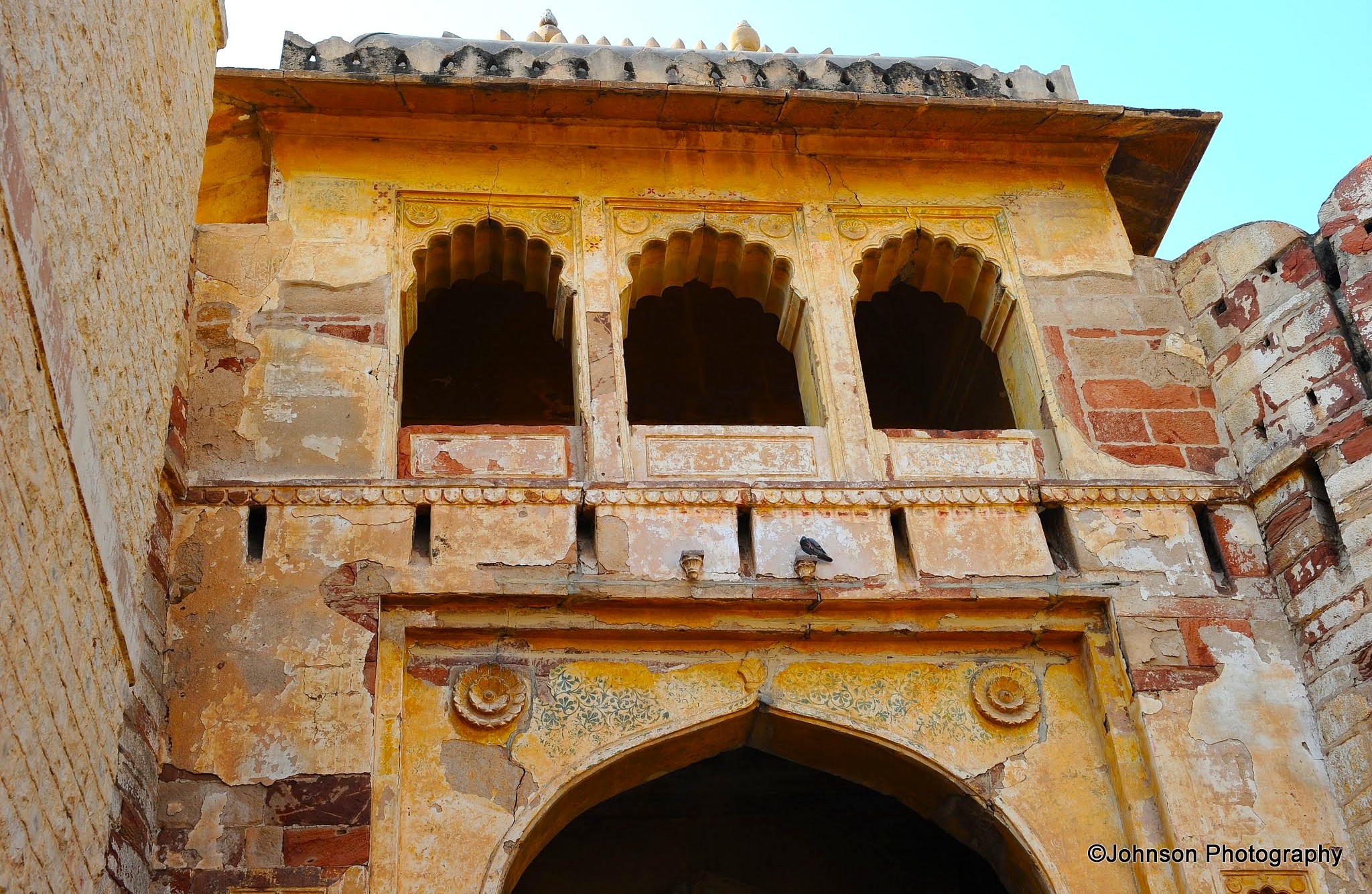 Ornate arches of Nagaur Fort in Rajasthan, India reveal intricate sandstone carvings and faded frescoes, reflecting centuries of heritage on the edge of the Thar Desert under a clear sky. Ornate arches of Nagaur Fort in Rajasthan, India reveal intricate sandstone carvings and faded frescoes, reflecting centuries of heritage on the edge of the Thar Desert under a clear sky.