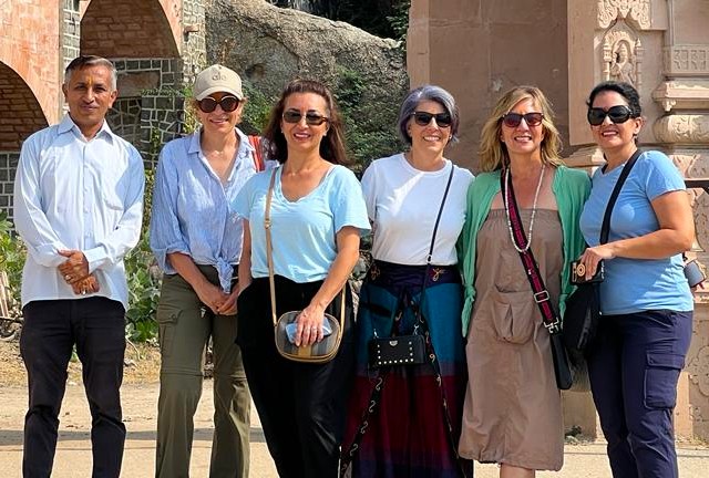 A group of six friends posing in front of the ornate gateway of Nagaur Fort in Rajasthan, India, with golden Thar Desert dunes behind, highlighting historic architecture and desert landscapes. A group of six friends posing in front of the ornate gateway of Nagaur Fort in Rajasthan, India, with golden Thar Desert dunes behind, highlighting historic architecture and desert landscapes.