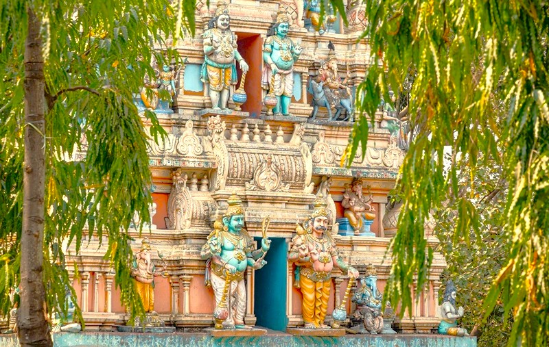 Front view of the intricately carved Nandi Bull Temple in Bangalore, Karnataka, India, near Mysore Palace, featuring the majestic sacred bull sculpture, traditional motifs, lush greenery, and serene spiritual ambiance. Front view of the intricately carved Nandi Bull Temple in Bangalore, Karnataka, India, near Mysore Palace, featuring the majestic sacred bull sculpture, traditional motifs, lush greenery, and serene spiritual ambiance.