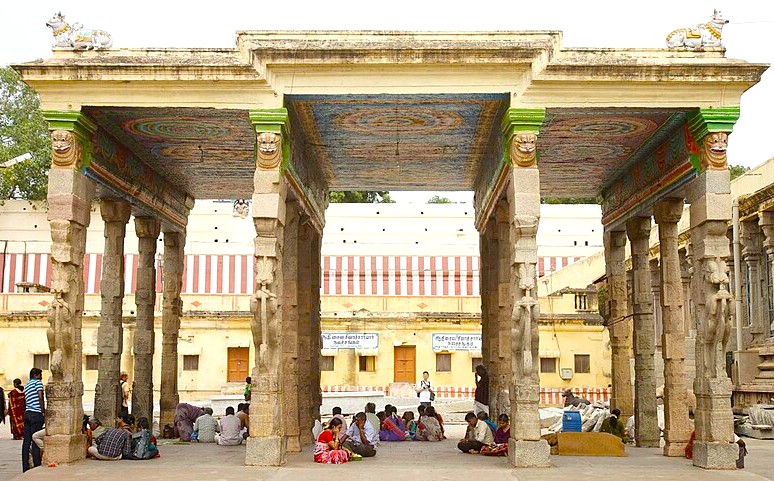 Historic nyaka gopuraum temple mandapa at Meenakshi Temple in Madurai, Tamil Nadu showcases ornate stone pillars, vibrant colorful painted ceilings and devotees in prayer, exemplifying South India’s rich Dravidian heritage. Historic nyaka gopuraum temple mandapa at Meenakshi Temple in Madurai, Tamil Nadu showcases ornate stone pillars, vibrant colorful painted ceilings and devotees in prayer, exemplifying South India’s rich Dravidian heritage.