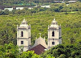 The twin towers of a historic Old Goa-Unesco church rise above lush forests, a sight near the Church of Saint Augustine in Goa, India, a state known for its beaches. The twin towers of a historic Old Goa-Unesco church rise above lush forests, a sight near the Church of Saint Augustine in Goa, India, a state known for its beaches.
