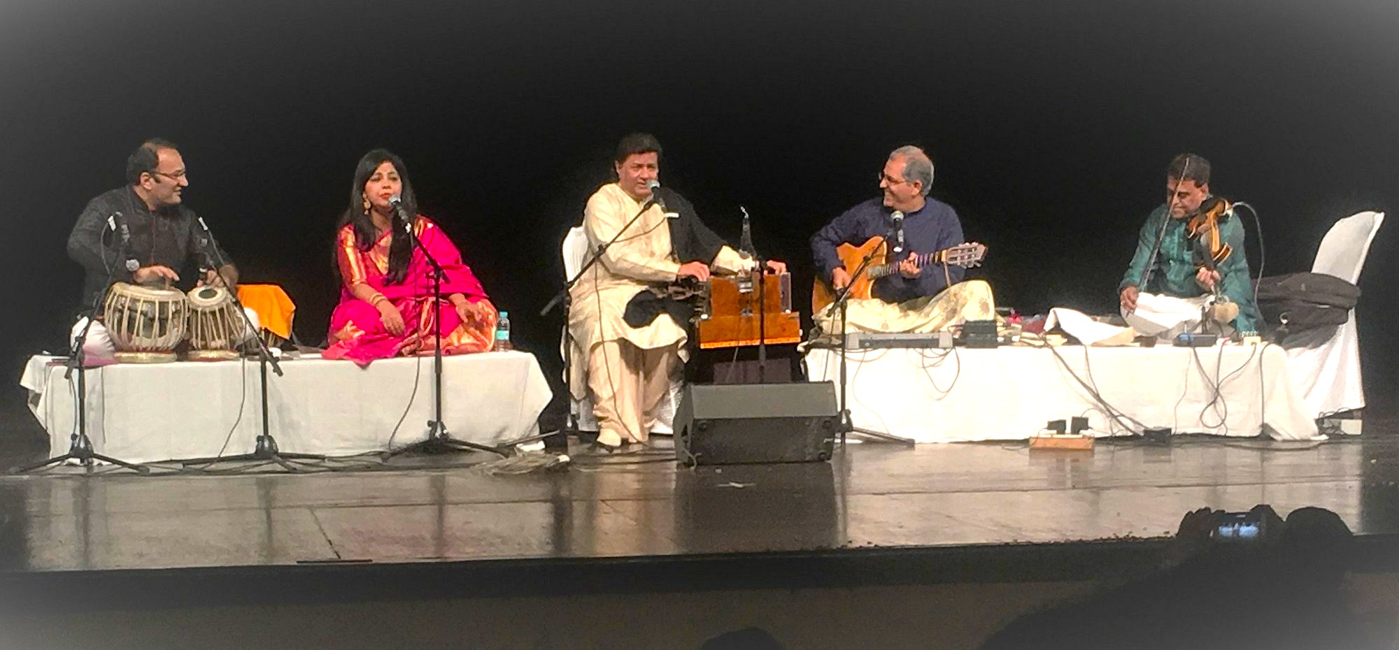 Ensemble of tabla, vocals, harmonium, guitar and violin performs riveting live Indian classical fusion on stage at India-Delhi - Karmani Auditorium, captivating audiences with rich melodies, heritage and immersive artistry. Ensemble of tabla, vocals, harmonium, guitar and violin performs riveting live Indian classical fusion on stage at India-Delhi - Karmani Auditorium, captivating audiences with rich melodies, heritage and immersive artistry.