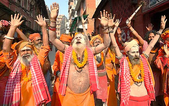 Hindu sadhus celebrate a religious festival with raised hands, reflecting the diverse spiritual traditions found in Srinagar, near Pari Mahal in Jammu and Kashmir, India, a UNESCO Creative Arts city.