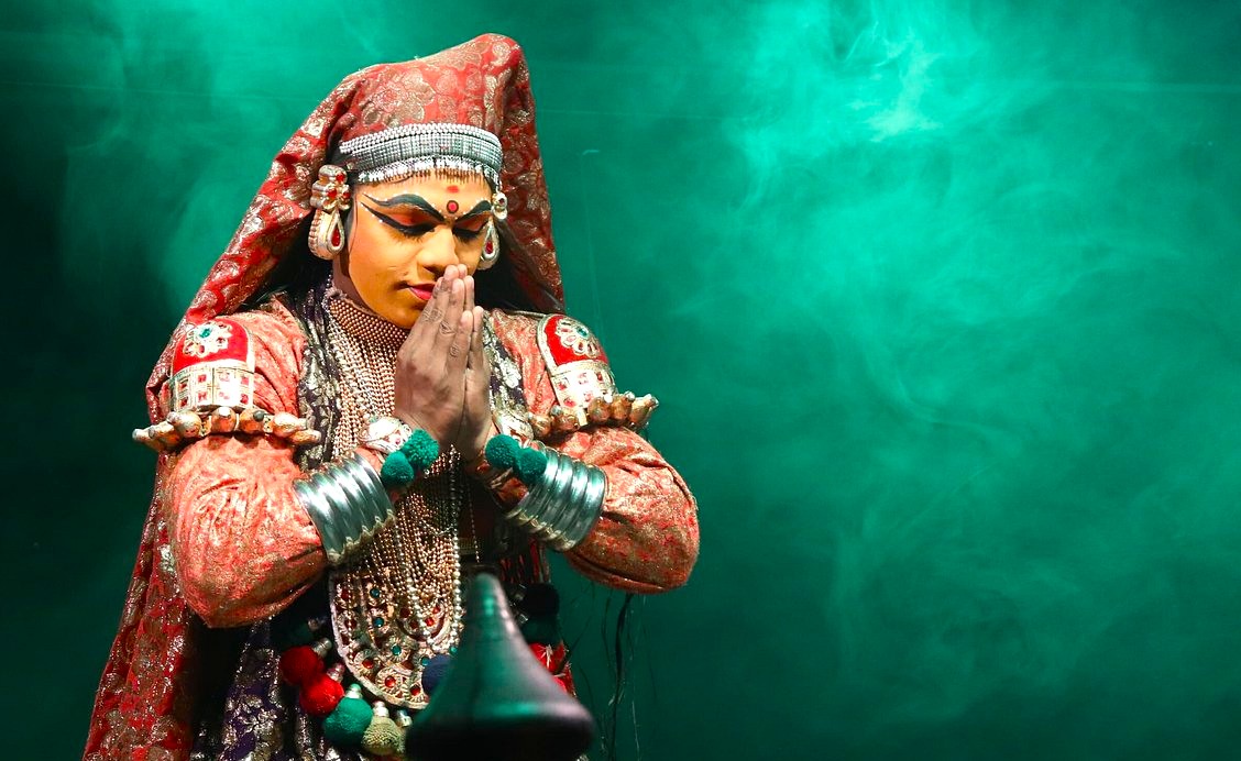 Kathakali performer in Punarjarni Village Munnar Kerala Southern India, dressed as mythological goddess, folds hands in prayer, showcasing traditional artistry and rich spiritual cultural heritage. Kathakali performer in Punarjarni Village Munnar Kerala Southern India, dressed as mythological goddess, folds hands in prayer, showcasing traditional artistry and rich spiritual cultural heritage.