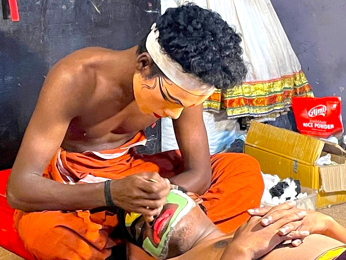 Traditional artist from Punarjani Village near Munnar, Kerala, Southern India, applies ceremonial kathakali face paint during cultural ritual performance, preserving ancient theatrical heritage through meticulous artistry. Traditional artist from Punarjani Village near Munnar, Kerala, Southern India, applies ceremonial kathakali face paint during cultural ritual performance, preserving ancient theatrical heritage through meticulous artistry.
