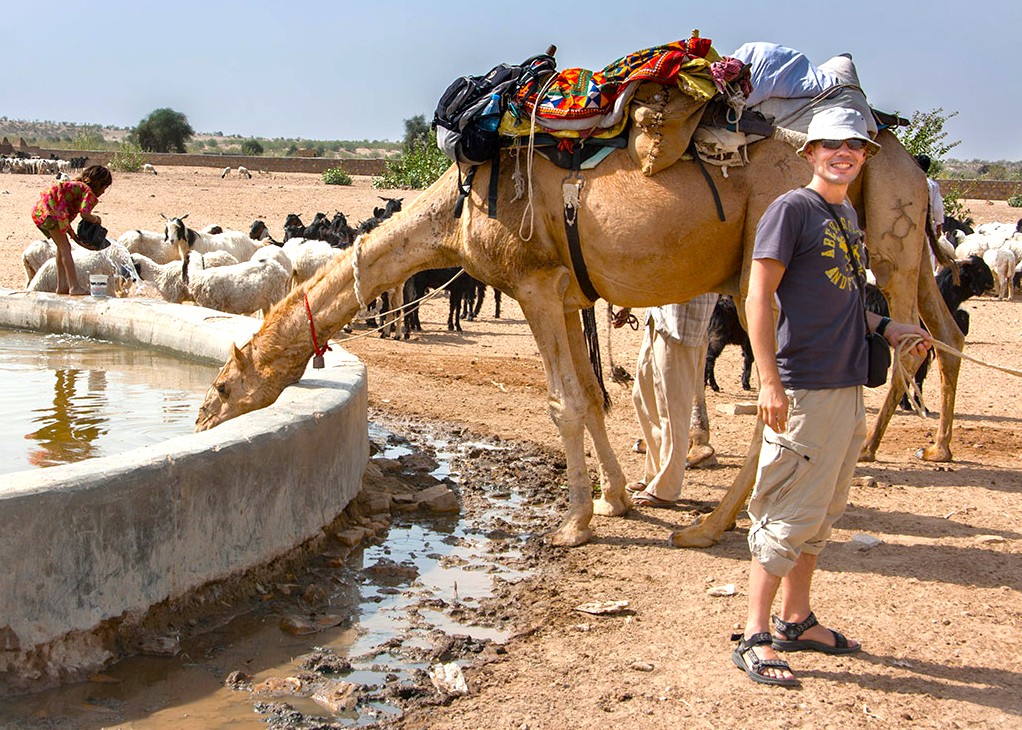 A traveler leads a camel to drink at a picturesque water trough beside Pushka Ghats in Rajasthan, India, between Jaipur and Agra on the way to the iconic Taj Mahal. A traveler leads a camel to drink at a picturesque water trough beside Pushka Ghats in Rajasthan, India, between Jaipur and Agra on the way to the iconic Taj Mahal.