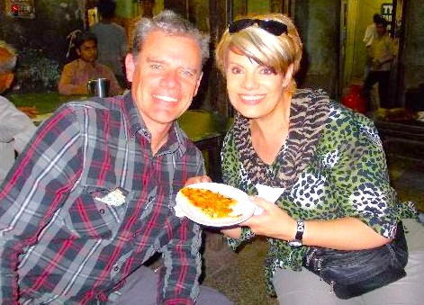 Tourists enjoy local street food in Delhi, India, a popular experience while visiting Unseco attractions like the Quttb Minar and the Red Foret.