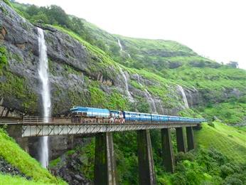 Experience India’s Maharashtra beauty aboard a scenic railway journey from Goa to Mumbai, passing roaring waterfalls, lush green hills, iconic bridges and panoramic hillside vistas that define Mumbai’s monsoon landscapes. Experience India’s Maharashtra beauty aboard a scenic railway journey from Goa to Mumbai, passing roaring waterfalls, lush green hills, iconic bridges and panoramic hillside vistas that define Mumbai’s monsoon landscapes.
