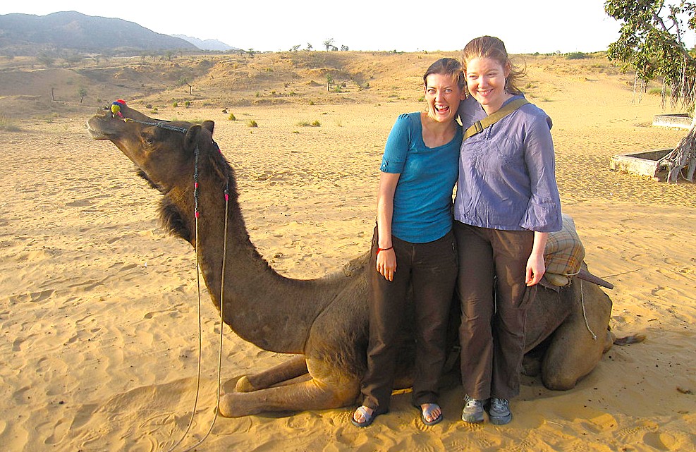 Two tourists share laughter atop a decorated camel amid the golden sands of Rajasthan’s Thar Desert near Bikaner, offering scenic desert safari experiences reminiscent of historic Rampura Havelis in India. Two tourists share laughter atop a decorated camel amid the golden sands of Rajasthan’s Thar Desert near Bikaner, offering scenic desert safari experiences reminiscent of historic Rampura Havelis in India.