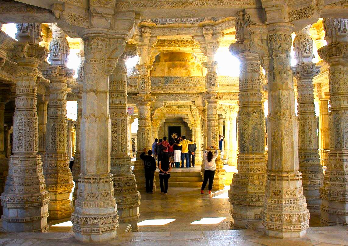Visitors admire intricate marble pillars and carved motifs inside the Ranakpur Jain Temple, nestled in the Aravali Hills near Jodhpur, Rajasthan, India, showcasing centuries-old magnificent spiritual architecture and sacred heritage. Visitors admire intricate marble pillars and carved motifs inside the Ranakpur Jain Temple, nestled in the Aravali Hills near Jodhpur, Rajasthan, India, showcasing centuries-old magnificent spiritual architecture and sacred heritage.