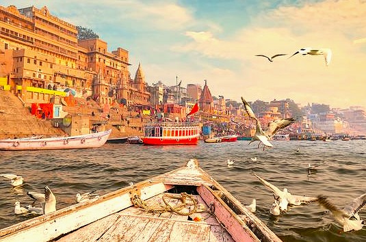  “Riverfront pilgrims gather at Dasaswamedh Ghat on the Ganges in Varanasi, India, near the Sarnath UNESCO site, experiencing sacred daily evening aarti ceremonies, historic architecture, cultural heritage, and spiritual devotion.”
