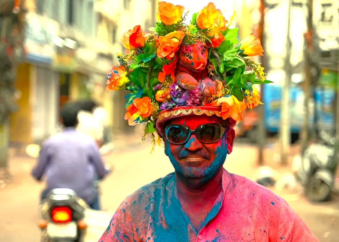 A man with a floral headdress celebrates the Holi festival in Goa, India, near Sahyadri Spice Farm, Karnataka, and the Old Goa St. Francis Church UNESCO churches. A man with a floral headdress celebrates the Holi festival in Goa, India, near Sahyadri Spice Farm, Karnataka, and the Old Goa St. Francis Church UNESCO churches.