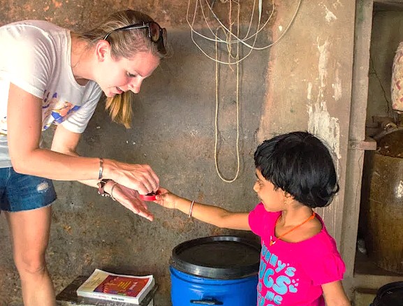 A tourist interacts with a local child at the Sahyadri Spice Farm in Goa, India, an attraction near Karnataka and the Old Goa St. Francis Church UNESCO churches. A tourist interacts with a local child at the Sahyadri Spice Farm in Goa, India, an attraction near Karnataka and the Old Goa St. Francis Church UNESCO churches.