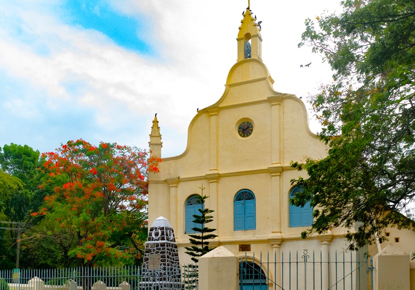 Historic Saint Francis Church in Fort Kochi, Kerala, South India, showcases colonial-era architecture, surrounded by lush greenery, seasonal blooms, tourists, coastal maritime heritage, reflecting Kochi’s rich cultural tapestry and legacy. Historic Saint Francis Church in Fort Kochi, Kerala, South India, showcases colonial-era architecture, surrounded by lush greenery, seasonal blooms, tourists, coastal maritime heritage, reflecting Kochi’s rich cultural tapestry and legacy.