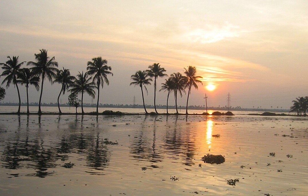 Tranquil backwaters at sunset in Kerala’s South India, with Saint Mary’s Basilica Kochi’s majestic distant spire reflecting in glowing golden waters amid a serene tropical landscape. Tranquil backwaters at sunset in Kerala’s South India, with Saint Mary’s Basilica Kochi’s majestic distant spire reflecting in glowing golden waters amid a serene tropical landscape.