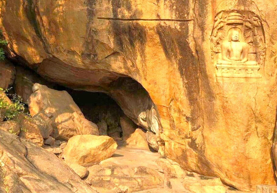 Ancient rock-cut cave and engraved Buddha statue at Samarnar Hills in Madurai, Tamil Nadu, South India showcase a serene, timeless historical monument reflecting spiritual heritage, cultural significance, and archaeological intrigue. Ancient rock-cut cave and engraved Buddha statue at Samarnar Hills in Madurai, Tamil Nadu, South India showcase a serene, timeless historical monument reflecting spiritual heritage, cultural significance, and archaeological intrigue.