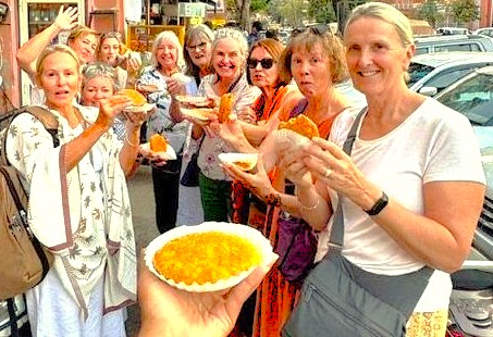 A group of tourists builds a friendly relationship while enjoying street food in Madurai, Tamil Nadu, a popular experience for travelers in India visiting Samarna Hills and Meenakshi Temple before heading to Munnar near the Unesco Western Ghats. A group of tourists builds a friendly relationship while enjoying street food in Madurai, Tamil Nadu, a popular experience for travelers in India visiting Samarna Hills and Meenakshi Temple before heading to Munnar near the Unesco Western Ghats.