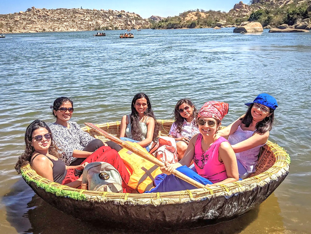 Enjoy a traditional coracle ride on Sanapur Lake in Hampi, a UNESCO site in Karnataka, India, near Vittala Temple, the elephant stables, and the historic Queen's Baths. Enjoy a traditional coracle ride on Sanapur Lake in Hampi, a UNESCO site in Karnataka, India, near Vittala Temple, the elephant stables, and the historic Queen's Baths.