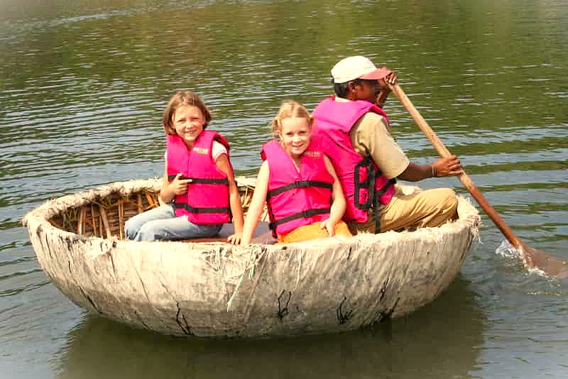 A family-friendly coracle ride on Sanapur Lake near Hippie Island in Hampi, a UNESCO site in Karnataka, India, near Vittala Temple and the historic Queen's Baths. A family-friendly coracle ride on Sanapur Lake near Hippie Island in Hampi, a UNESCO site in Karnataka, India, near Vittala Temple and the historic Queen's Baths.