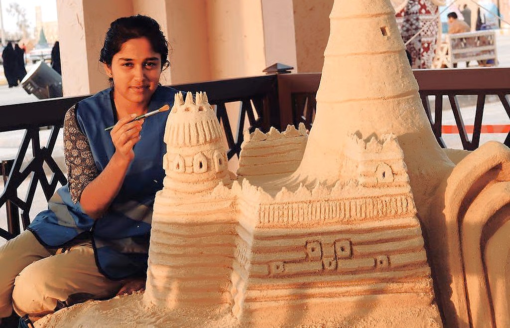 “Artist M.N. Gowri creates intricate sand sculptures at Mysore Sand Sculpture Museum in Mysore, Karnataka, India, showcasing architectural artistry, cultural heritage, and innovative sandcastle designs.”