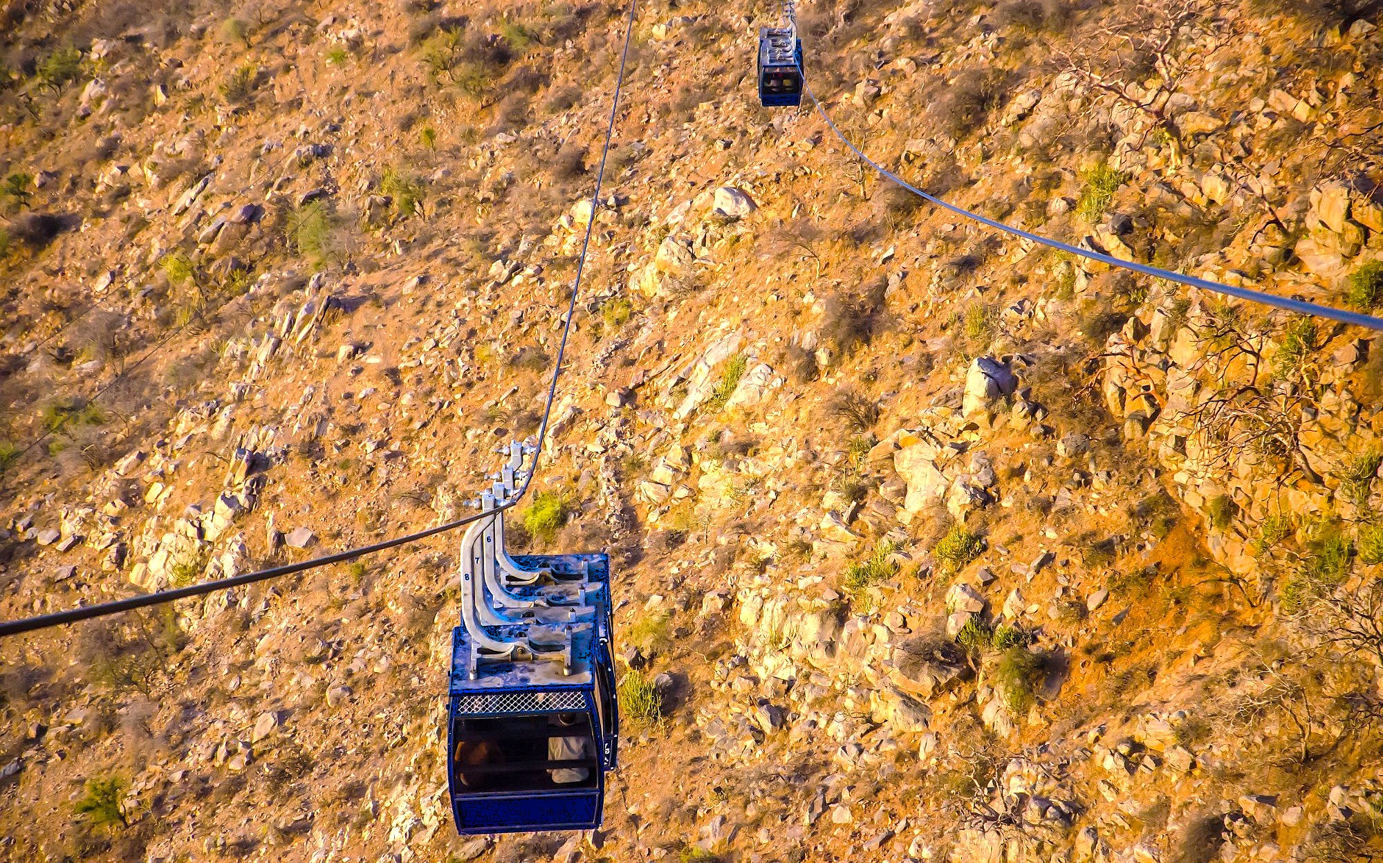 A cable car transports travelers along the Savitri Temple Rope Way in Pushka, Rajasthan, India, soaring over Ajmer’s hills between Jaipur and Agra on the route to the Taj Mahal.