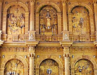 Intricate gilded carvings depicting religious figures and scenes on the elaborate main altar of Se Cathedral, one of the historic Unesco churches in Old Goa, Goa, India.