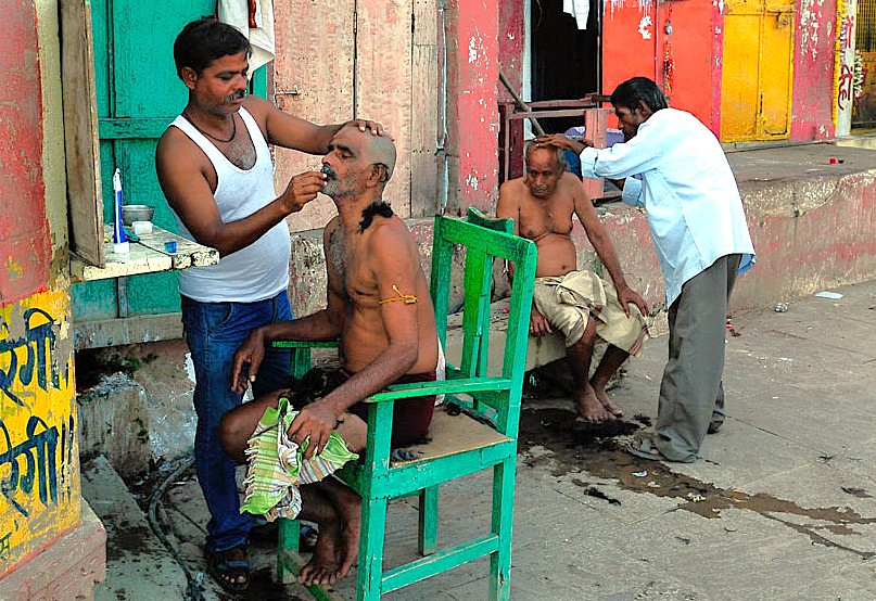Indian street barbers offer shaves, a slice of local culture for tourists visiting Goa's beaches and the historic Se Cathedral, one of the Old Goa Unesco churches in India.