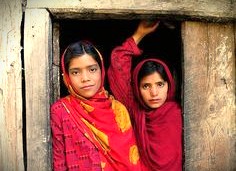 Two Kashmiri girls in vibrant clothing reflect the local culture near Shankaracharya Hill, a major landmark in Srinagar, Kashmir-India, the UNESCO City of Arts, near the Himalayas. Two Kashmiri girls in vibrant clothing reflect the local culture near Shankaracharya Hill, a major landmark in Srinagar, Kashmir-India, the UNESCO City of Arts, near the Himalayas.