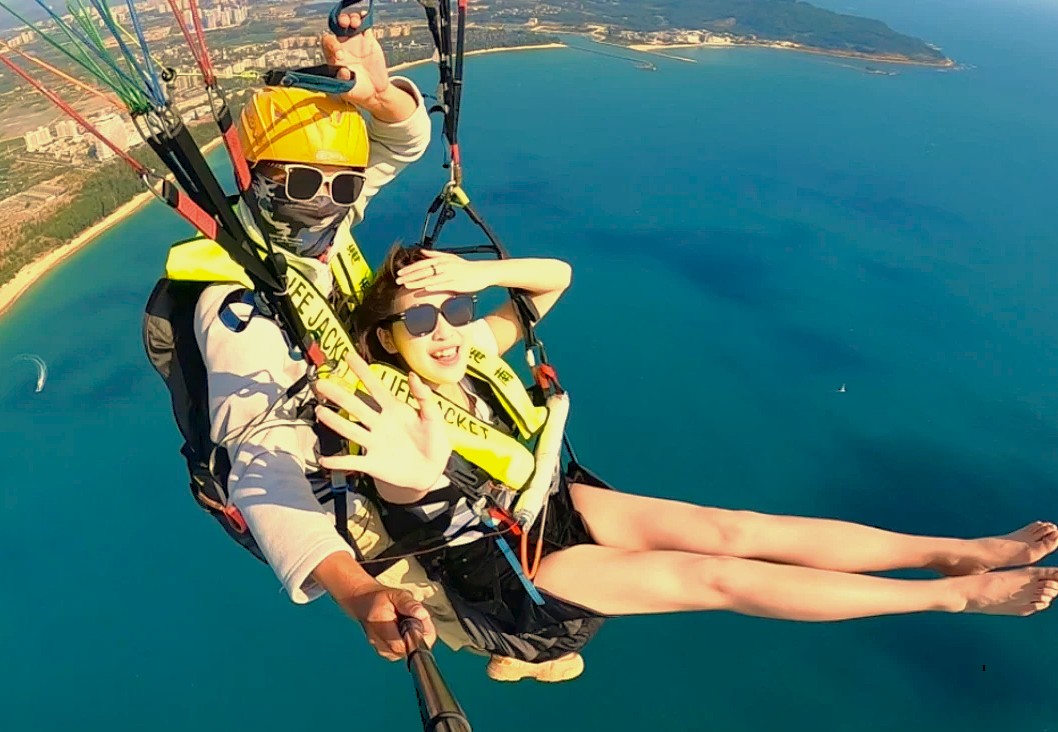 Tourists enjoy thrilling paragliding adventures near Sinthan Top, showcasing the extreme sports available in the Himalayas of Kashmir-India, a scenic drive from Srinagar, the UNESCO City of Arts.