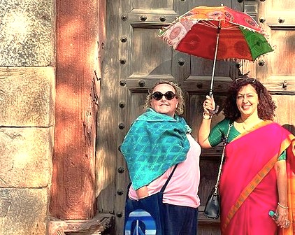 Smiling tourists pose in vibrant Indian textiles, reflecting the local culture and hospitality near high-altitude sites like Sinthan Top and Shankaracharya Hill in Kashmir-India.