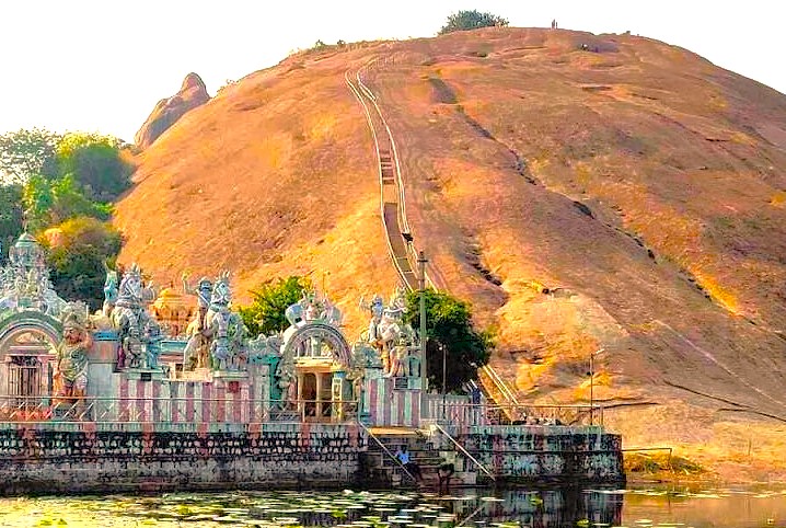 The steep climb up Samarna Hills in Madurai, Tamil Nadu, visualizes the sacred relationship between pilgrims and the divine, a memorable excursion for tourists in India visiting Meenakshi Temple before travelling to Munnar and the Unesco Western Ghats. The steep climb up Samarna Hills in Madurai, Tamil Nadu, visualizes the sacred relationship between pilgrims and the divine, a memorable excursion for tourists in India visiting Meenakshi Temple before travelling to Munnar and the Unesco Western Ghats.