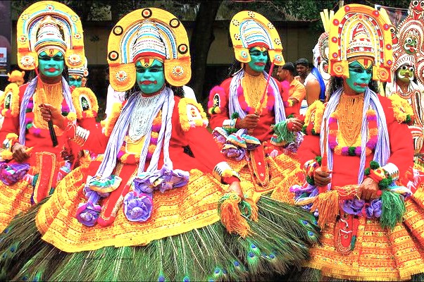Vibrant South India festival procession showcases Kathakali dancers adorned in elaborate masks and costumes, rich cultural heritage including Mysore palaces, Hampi ruins, Bangalore, Madurai temples.