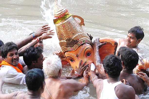 Devotees in South India immerse Lord Ganesha idols in sacred river waters for Ganesh Chaturthi, a vibrant festival celebrated from Madurai through Mysore, Bangalore, Hampi.
