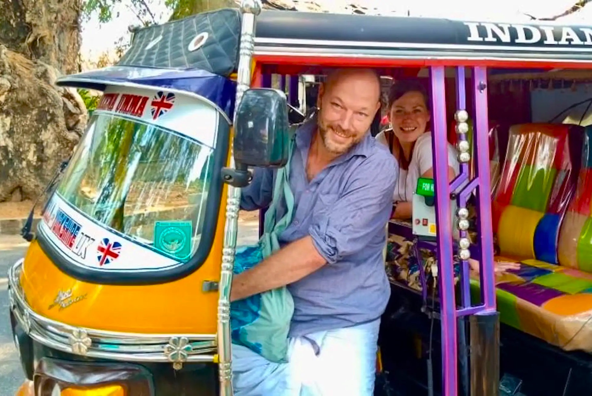 Colorful tuk-tuk carrying smiling tourists navigates a bustling Spice Market in Kochi, Kerala, South India, where vibrant storefronts overflow with aromatic turmeric, cardamom, pepper and chili, inviting sensory cultural discovery. Colorful tuk-tuk carrying smiling tourists navigates a bustling Spice Market in Kochi, Kerala, South India, where vibrant storefronts overflow with aromatic turmeric, cardamom, pepper and chili, inviting sensory cultural discovery.