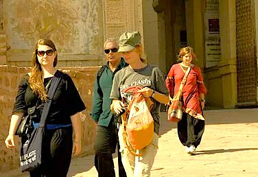 Tourists walk past historic stone archways near the Sri Pratap Museum, exploring the heritage of Srinagar, Kashmir-India, the UNESCO City of Arts, near the Himalayas. Tourists walk past historic stone archways near the Sri Pratap Museum, exploring the heritage of Srinagar, Kashmir-India, the UNESCO City of Arts, near the Himalayas.