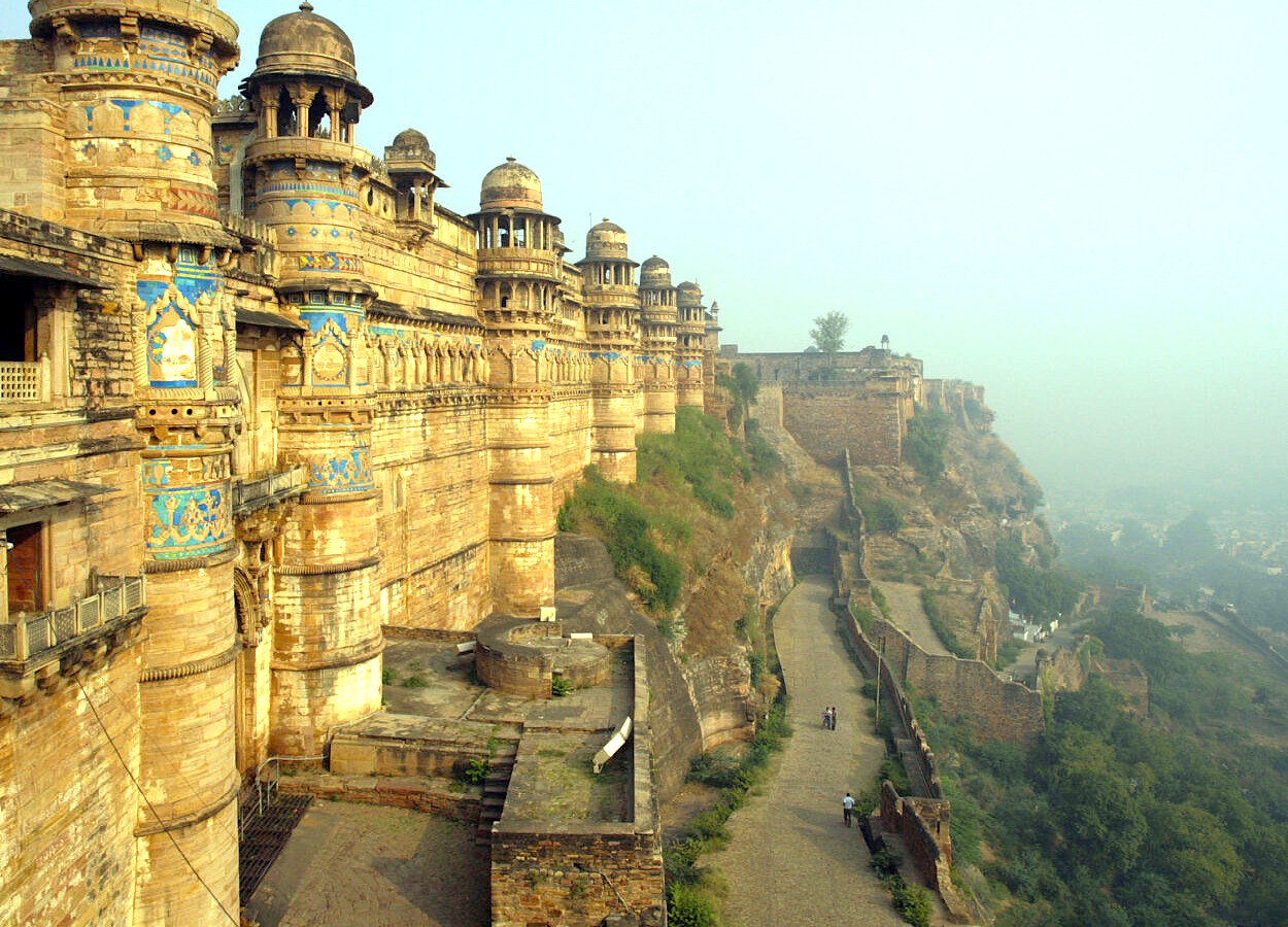 Ancient sandstone fortress perched on a rocky hill in Tamil Nadu, southern India, features intricate carvings and domed towers showcasing cultural heritage of southern India. Ancient sandstone fortress perched on a rocky hill in Tamil Nadu, southern India, features intricate carvings and domed towers showcasing cultural heritage of southern India.