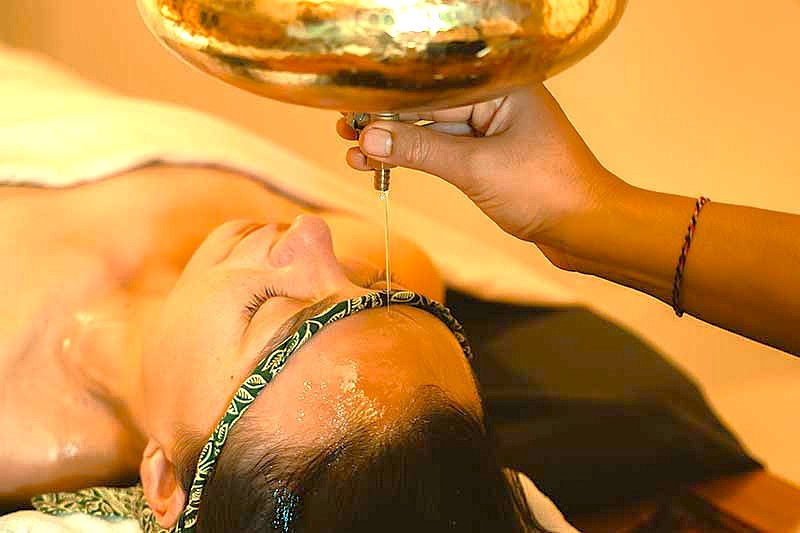 Experience rejuvenating Ayurvedic Shirodhara therapy in Maharashtra, Western India, a peaceful stop on a cultural journey through India traveling via the UNESCO Ellora and Ajanta Caves to sacred Varanasi.