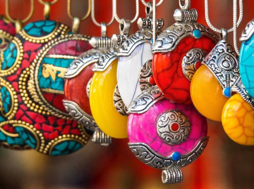 “A vibrant crowd of shoppers explores colorful textile and jewelry stalls, admiring handcrafted accessories and ethnic patterns under hanging lanterns at Delhi’s famous Tibetan Market in India’s bustling artisan bazaar.”  “A vibrant crowd of shoppers explores colorful textile and jewelry stalls, admiring handcrafted accessories and ethnic patterns under hanging lanterns at Delhi’s famous Tibetan Market in India’s bustling artisan bazaar.”