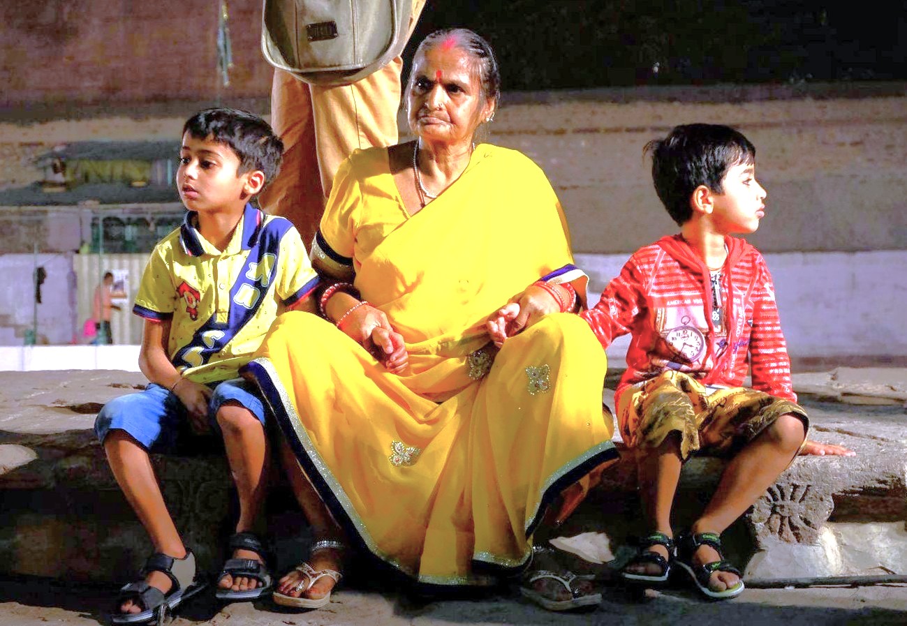 A local grandmother rests with her two grandsons at the bustling Tibetan Market in Delhi, India, a popular shopping area near UNESCO sites like the Qutb Minar, the UNESCO Red Fort, and the UNESCO Humayun's Tomb. A local grandmother rests with her two grandsons at the bustling Tibetan Market in Delhi, India, a popular shopping area near UNESCO sites like the Qutb Minar, the UNESCO Red Fort, and the UNESCO Humayun's Tomb.