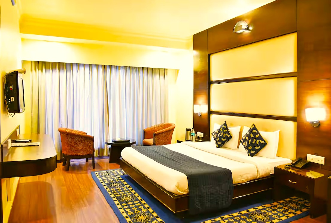 Modern interior of a spacious India 3 to 5 star hotel room featuring a plush king bed, wooden floors, and seating area, perfect for travelers seeking luxury accommodation and premium amenities Modern interior of a spacious India 3 to 5 star hotel room featuring a plush king bed, wooden floors, and seating area, perfect for travelers seeking luxury accommodation and premium amenities