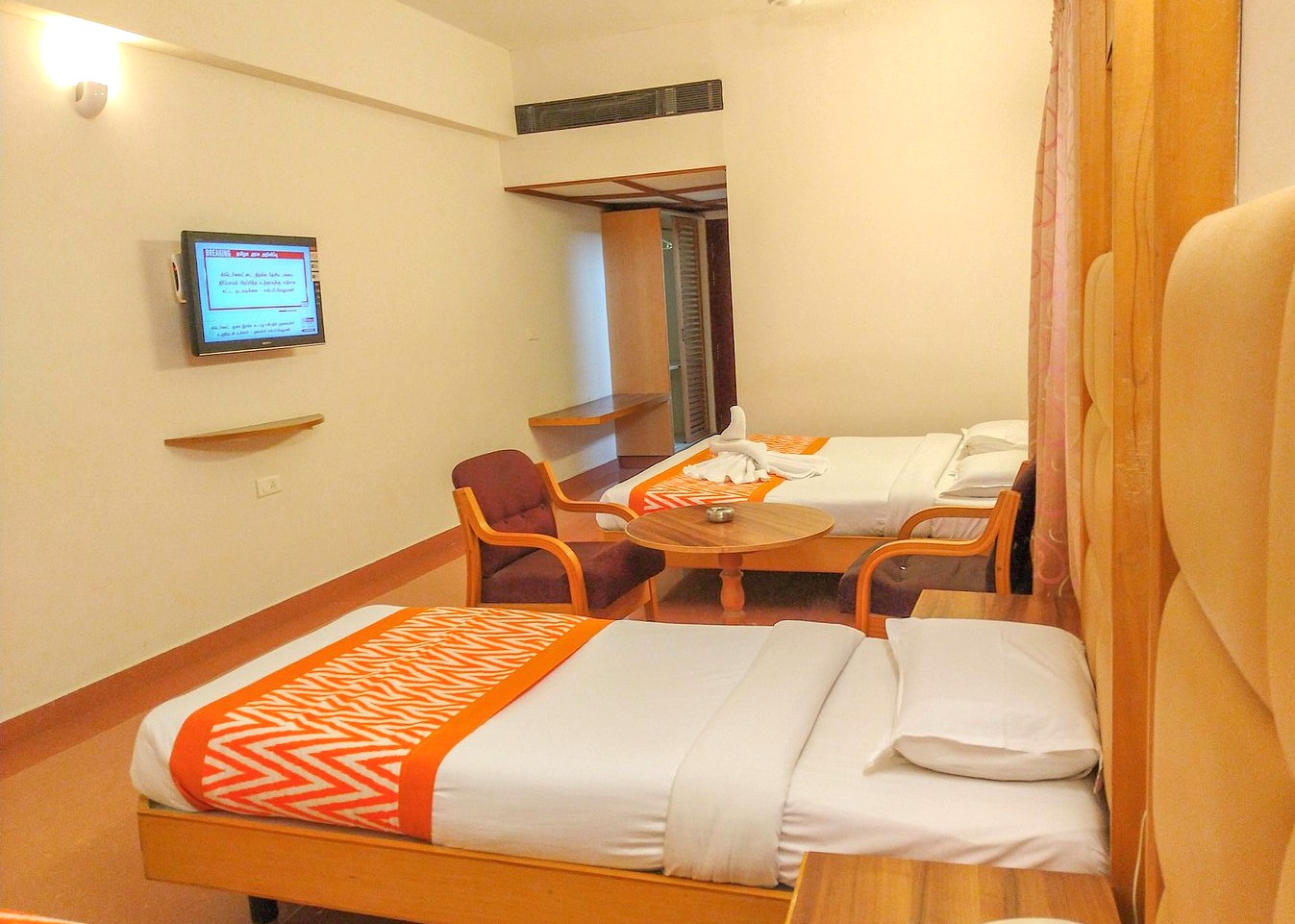 "Interior of a clean 1 to 3 star hotel room in India featuring comfortable twin beds and tiled floors, illustrating the standard accommodation available when comparing the cost of different tour types." "Interior of a clean 1 to 3 star hotel room in India featuring comfortable twin beds and tiled floors, illustrating the standard accommodation available when comparing the cost of different tour types."
