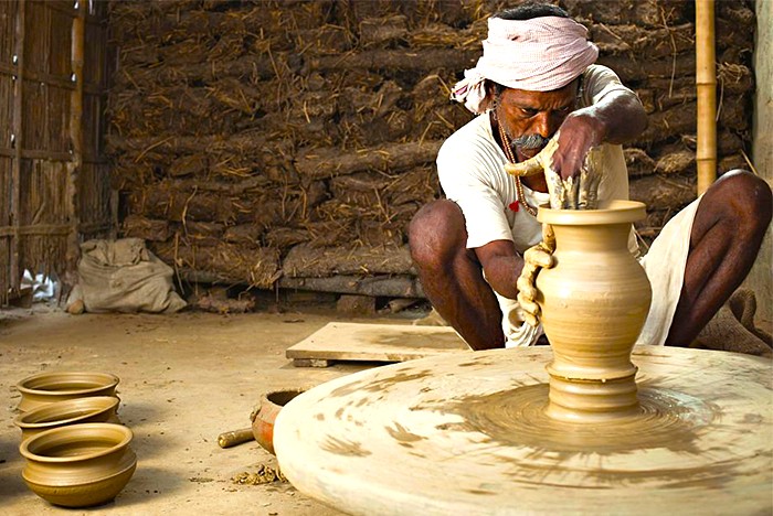 Skilled artisan potter shapes clay vessels in a rustic workshop near Tooji Ka Jhalra step well in Jodhpur, Rajasthan, India, preserving centuries-old craftsmanship and vibrant cultural heritage through handmade pottery. Skilled artisan potter shapes clay vessels in a rustic workshop near Tooji Ka Jhalra step well in Jodhpur, Rajasthan, India, preserving centuries-old craftsmanship and vibrant cultural heritage through handmade pottery.