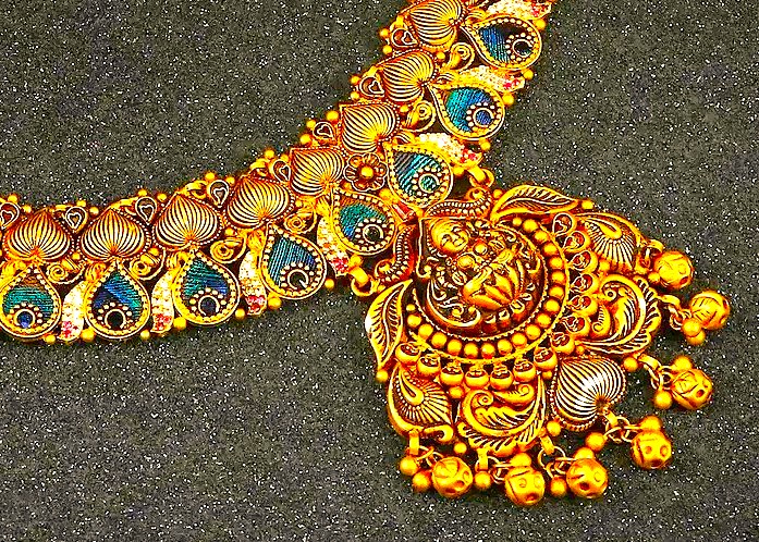An exquisite, traditional gold necklace showcases the intricate craftsmanship famous in India, particularly in Tamil Nadu. Such fine jewelry can be found in the Town Hall Markets of Coimbatore, a major shopping destination for tourists visiting the hill stations of Kodaikanal and Ooty. An exquisite, traditional gold necklace showcases the intricate craftsmanship famous in India, particularly in Tamil Nadu. Such fine jewelry can be found in the Town Hall Markets of Coimbatore, a major shopping destination for tourists visiting the hill stations of Kodaikanal and Ooty.
