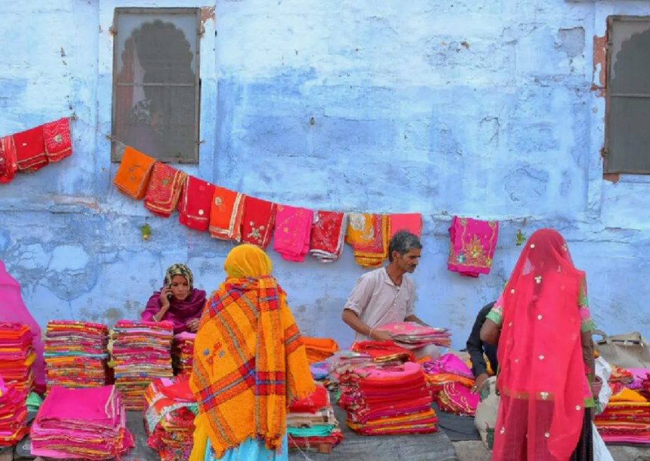 Vibrant Udaipur market scene in Rajasthan, India showing bustling local vendors selling colorful handwoven textiles and saris, capturing authentic everyday life, traditional craftsmanship, rich cultural heritage and immersive shopping experience. Vibrant Udaipur market scene in Rajasthan, India showing bustling local vendors selling colorful handwoven textiles and saris, capturing authentic everyday life, traditional craftsmanship, rich cultural heritage and immersive shopping experience.
