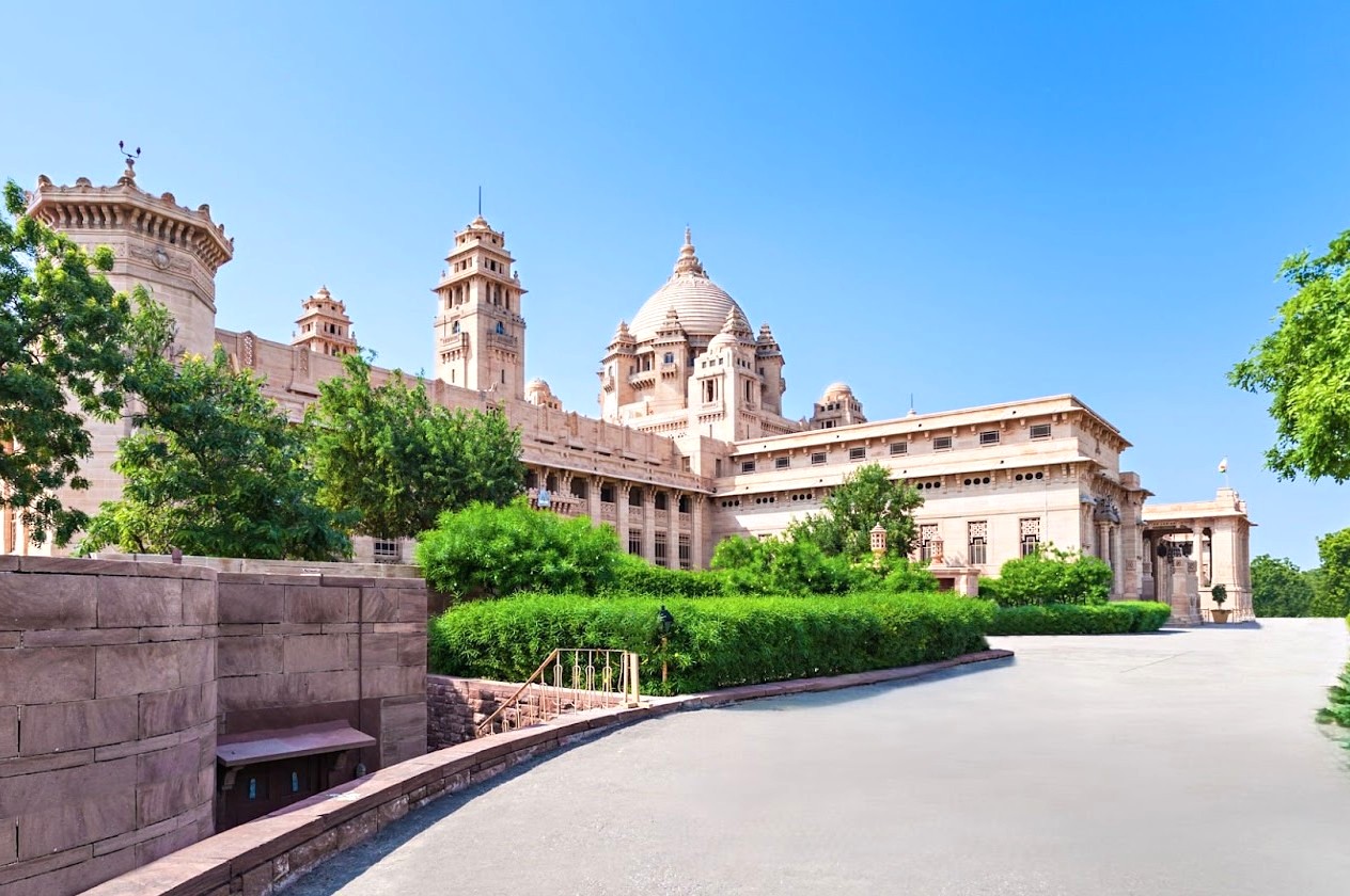 Epitome of royal Rajasthani heritage, Umaid Bhawan Palace in Jodhpur, Rajasthan, India, showcases majestic sandstone domes, intricate Mughal-inspired facades, lush gardens and grand entrances, making it a must-visit historical landmark.