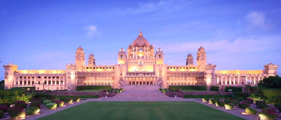 “Umaid Bhawan Palace in Jodhpur, Rajasthan, India showcases stunning opulent Indo-Saracenic architecture with ornate domes, minarets, lush gardens, golden lighting, historic museum exhibits, royal heritage ambiance and panoramic landscaped vistas.”