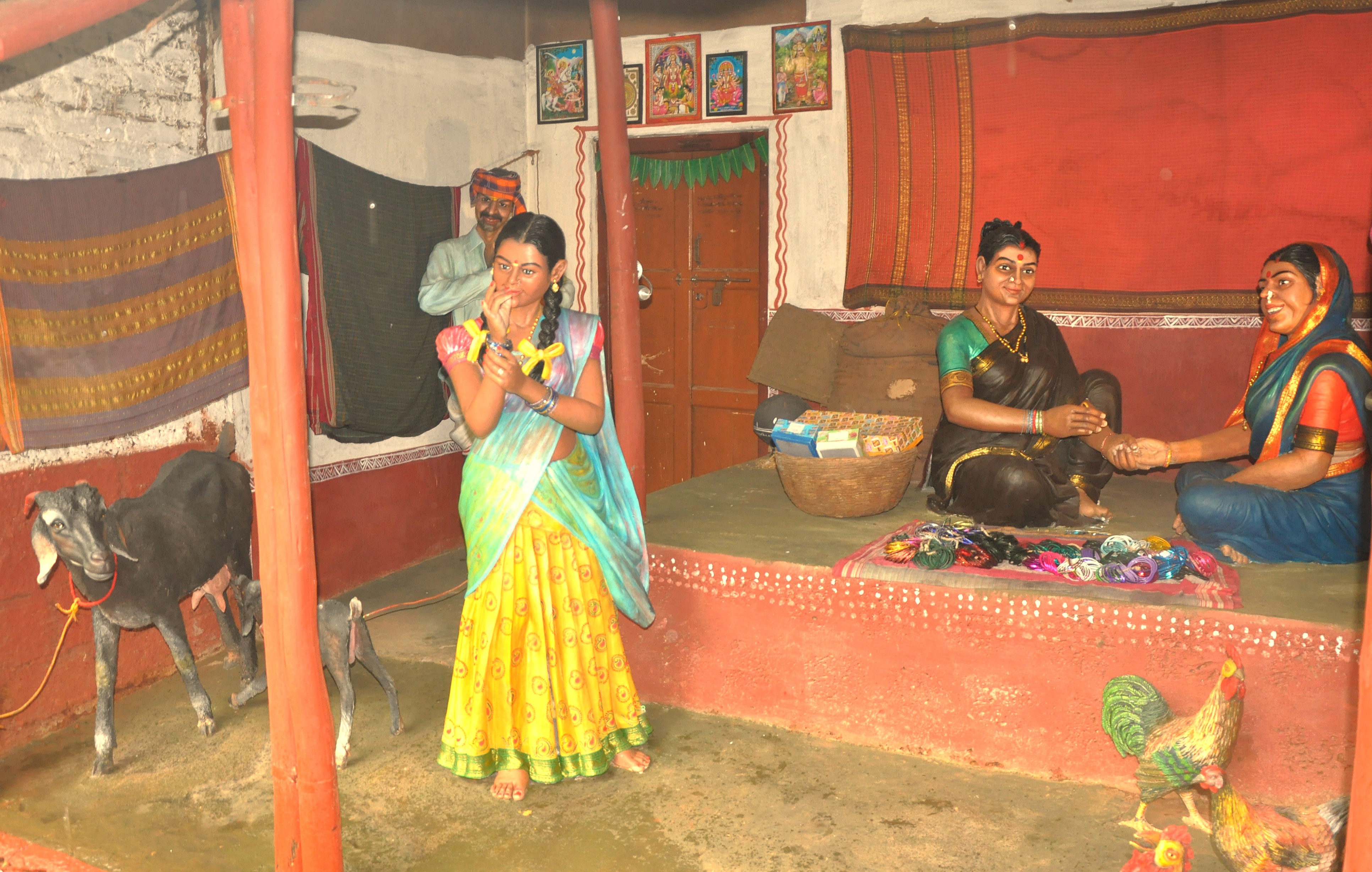 A realistic diorama of a traditional village home scene at Utsav Rock Garden in Hubli, Karnataka, India, a cultural stop on a road trip near-Goa's Unesco Churches. A realistic diorama of a traditional village home scene at Utsav Rock Garden in Hubli, Karnataka, India, a cultural stop on a road trip near-Goa's Unesco Churches.