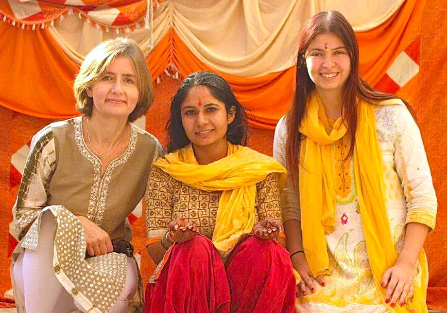 Tourists and a local woman pose together at Utsav Rock Garden in Hubli, Karnataka, India, a cultural stop on a road trip near-Goa's Unesco Churches. Tourists and a local woman pose together at Utsav Rock Garden in Hubli, Karnataka, India, a cultural stop on a road trip near-Goa's Unesco Churches.